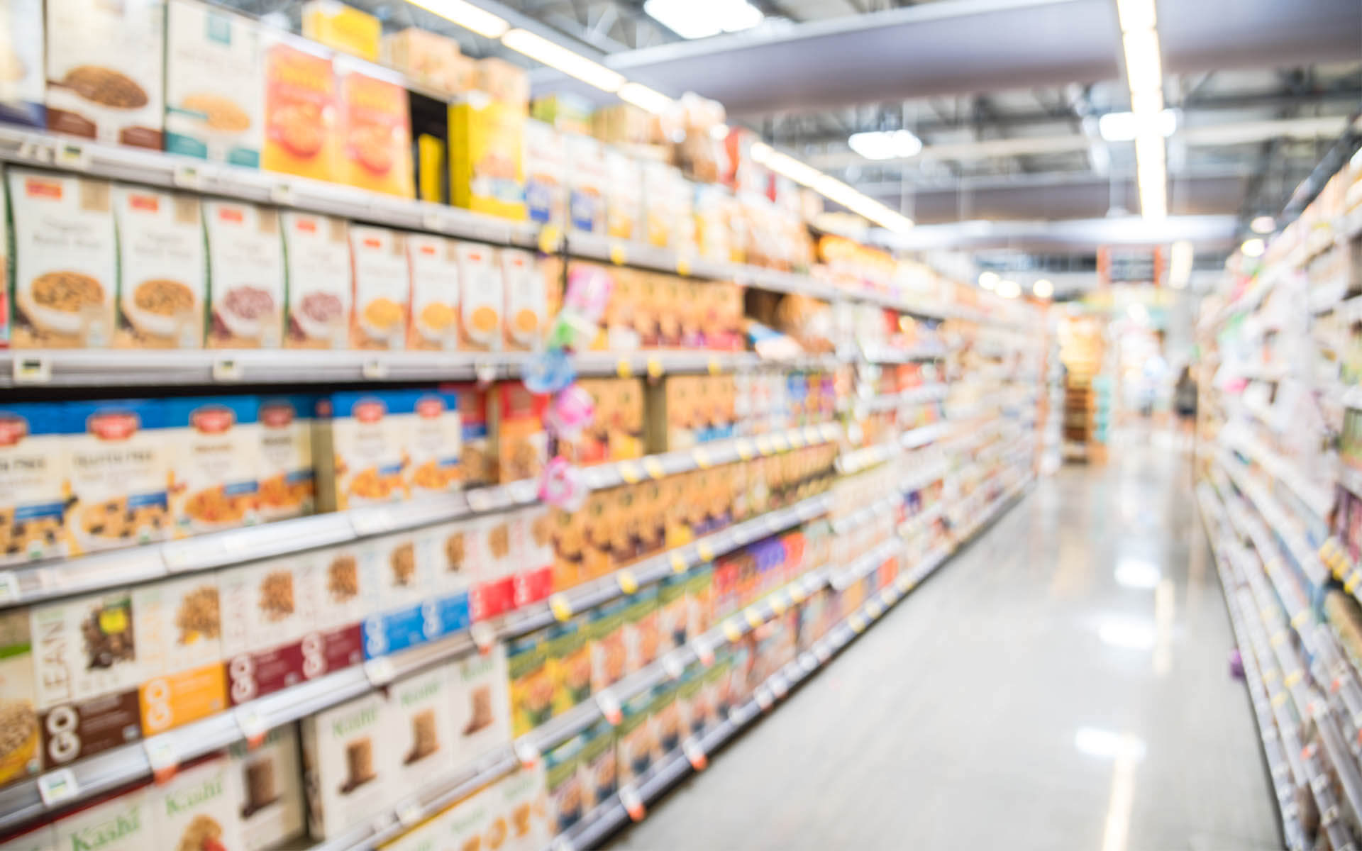 A colorful grocery store aisle displaying shelves filled with an assortment of food items, inviting customers to explore.