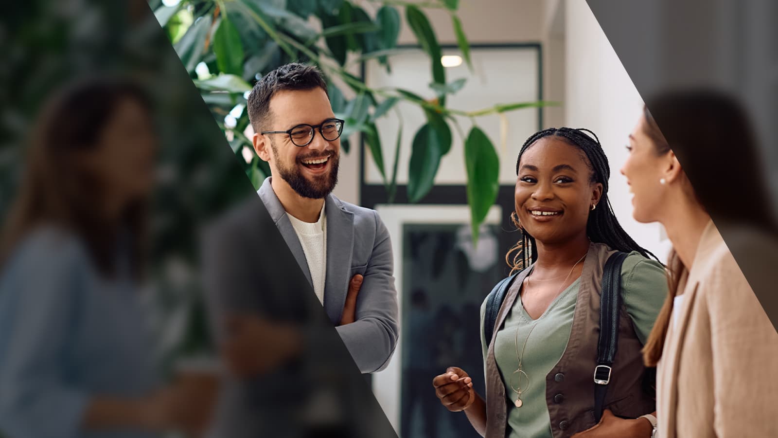 A diverse group of business professionals smiling and discussing ideas in a collaborative environment.